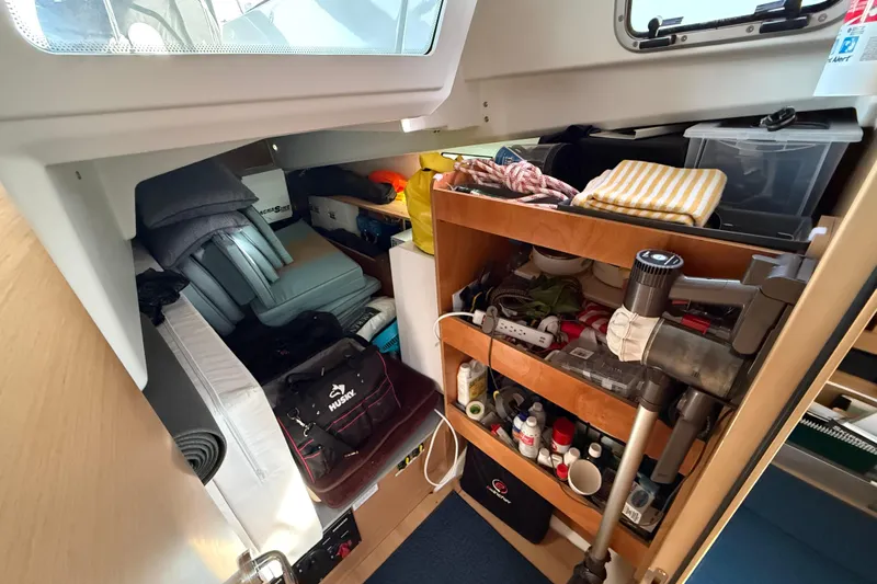 Lost Traveler Yacht Photos Pics Interior storage of 2020 Jeanneau Sun Odyssey 440 yacht, featuring organized shelves and equipment.