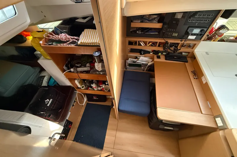 Lost Traveler Yacht Photos Pics Interior of 2020 Jeanneau Sun Odyssey 440 sailboat, featuring organized storage and navigation station.