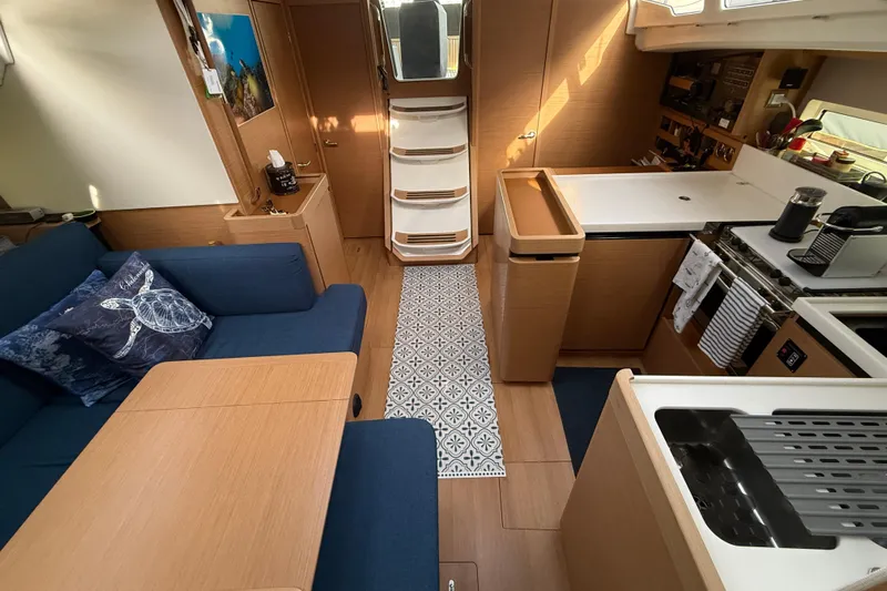 Lost Traveler Yacht Photos Pics Interior of 2020 Jeanneau Sun Odyssey 440 yacht, featuring modern kitchen and cozy seating area.