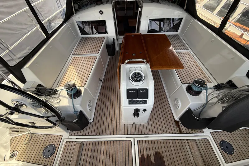 Lost Traveler Yacht Photos Pics 2020 Jeanneau Sun Odyssey 440 cockpit with wooden flooring and navigation equipment.