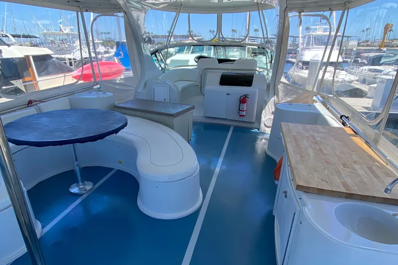 Dianne Yacht Photos Pics Interior of 2003 Bluewater Yachts 6000, featuring seating, table, and kitchenette.