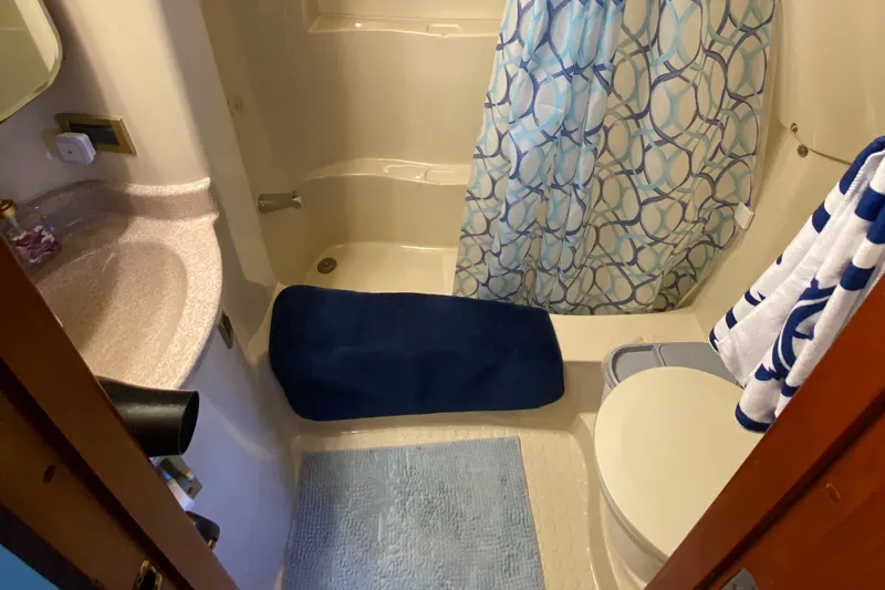 Dianne Yacht Photos Pics Bathroom interior of 2003 Bluewater Yachts 6000, featuring shower and blue accents.