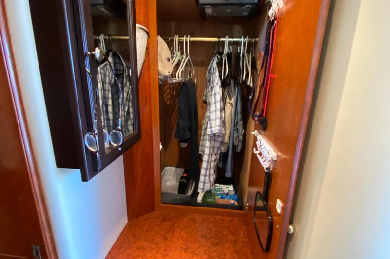 Dianne Yacht Photos Pics Closet interior on 2003 Bluewater Yachts 6000 custom series, featuring hanging clothes and accessories.