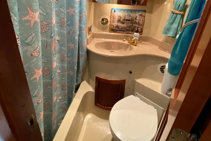 Dianne Yacht Photos Pics Bathroom in 2003 Bluewater Yachts 6000, featuring nautical decor and compact design.