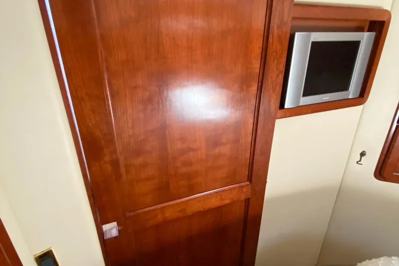 Dianne Yacht Photos Pics Wooden interior door and wall-mounted TV in 2003 Bluewater Yachts 6000 custom series.
