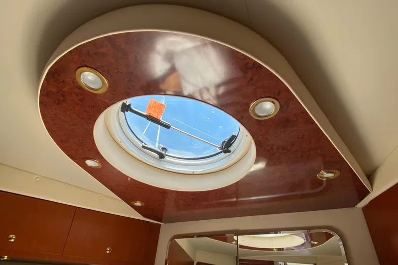 Dianne Yacht Photos Pics Interior view of 2003 Bluewater Yachts 6000, featuring a circular skylight and wood paneling.