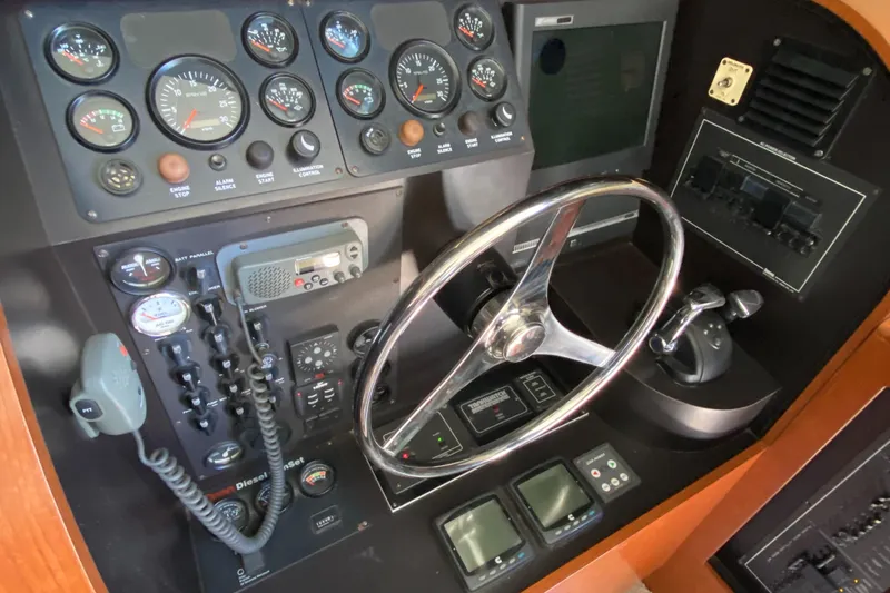 Dianne Yacht Photos Pics Control panel of a 2003 Bluewater Yachts 6000 custom series with gauges and steering wheel.