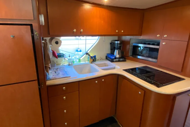 Dianne Yacht Photos Pics 2003 Bluewater Yachts 6000 custom series kitchen with wooden cabinets and modern appliances.