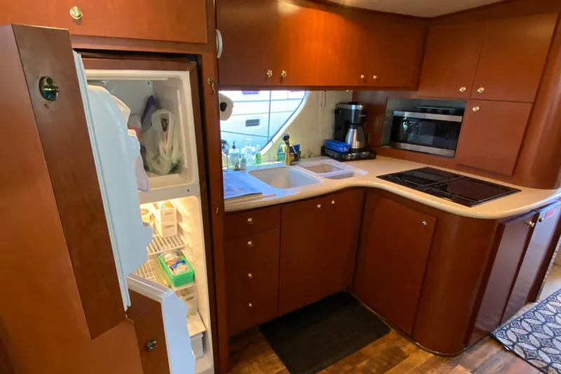Dianne Yacht Photos Pics 2003 Bluewater Yachts 6000 custom series kitchen with open fridge, sink, and appliances.