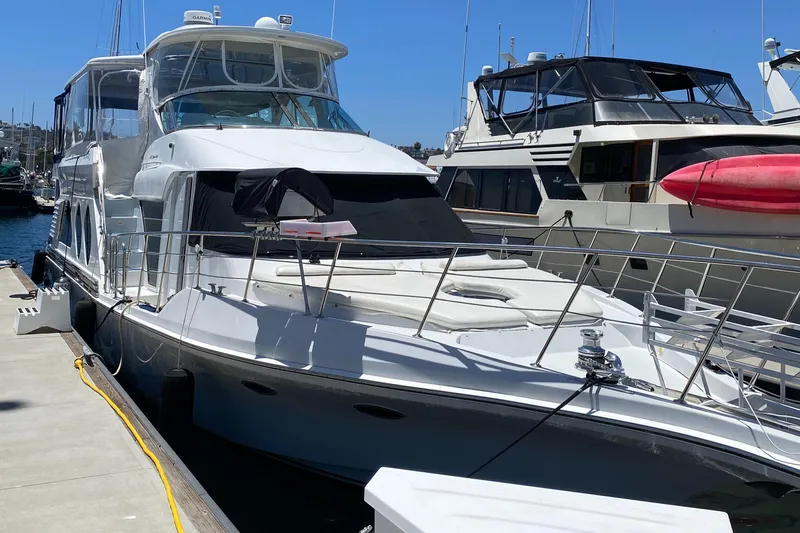 Dianne Yacht Photos Pics 2003 Bluewater Yachts 6000 Custom Series docked at marina, sunny day.