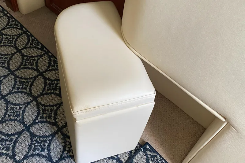 Dianne Yacht Photos Pics White cushioned seat on Bluewater Yachts 6000 custom series, 2003 model, with patterned carpet.