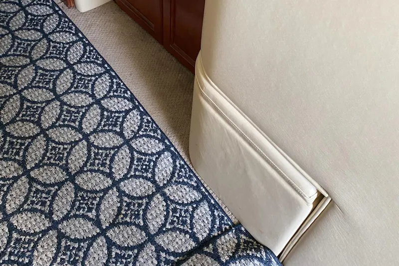 Dianne Yacht Photos Pics Interior of 2003 Bluewater Yachts 6000, featuring patterned carpet and beige upholstery.