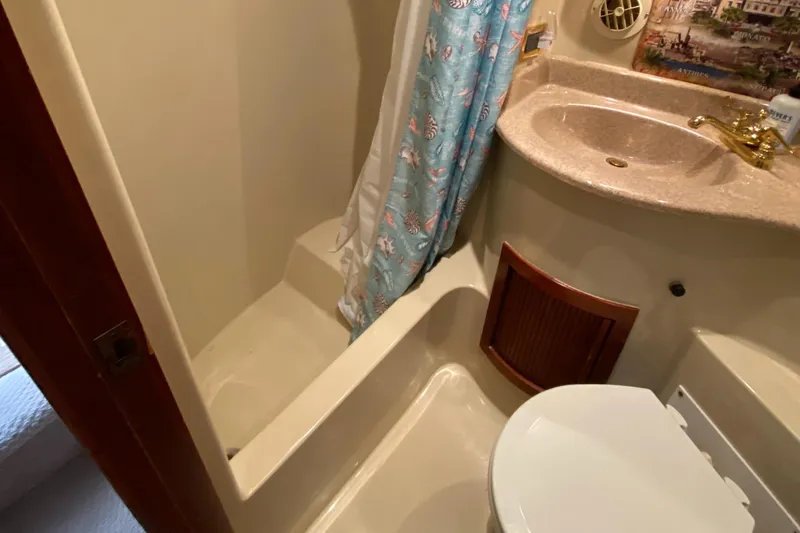 Dianne Yacht Photos Pics Bathroom in 2003 Bluewater Yachts 6000 Custom Series, featuring shower, sink, and toilet.