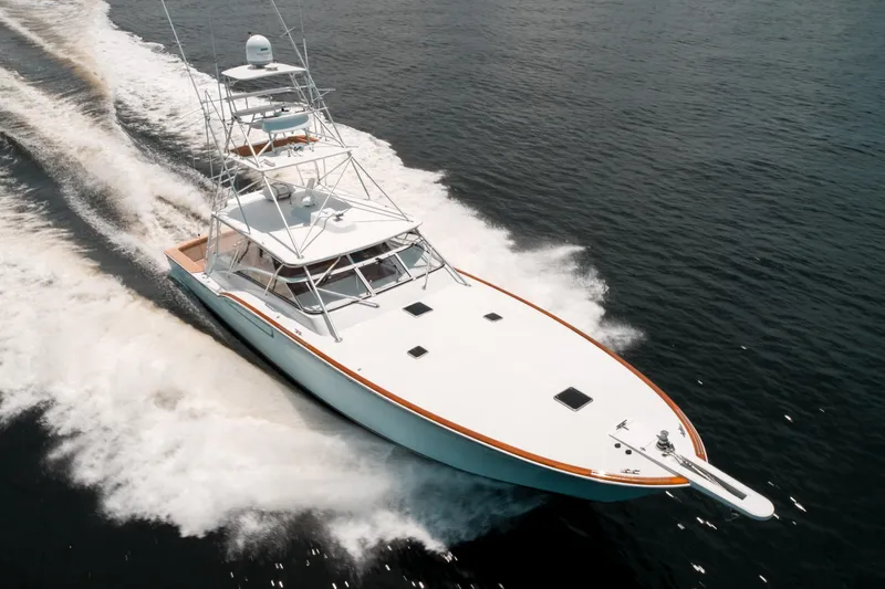Reel Tycoon Yacht Photos Pics 2004 Donzi R-58 Express yacht cruising swiftly on open water.