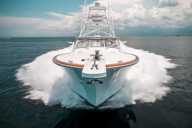 Reel Tycoon Yacht Photos Pics 2004 Donzi R-58 Express yacht cruising on open water, creating a dynamic wake.