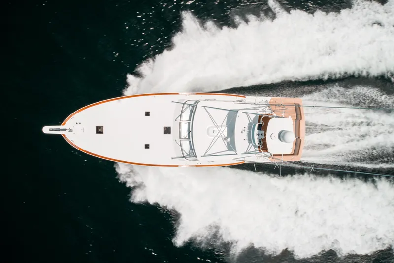 Reel Tycoon Yacht Photos Pics Aerial view of 2004 Donzi R-58 Express yacht speeding on water.