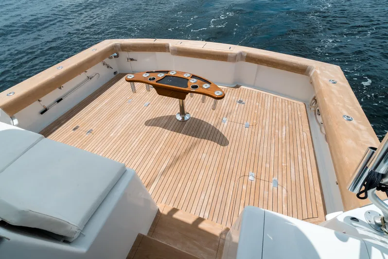 Reel Tycoon Yacht Photos Pics 2004 Donzi R-58 Express yacht deck with wooden flooring and central table.