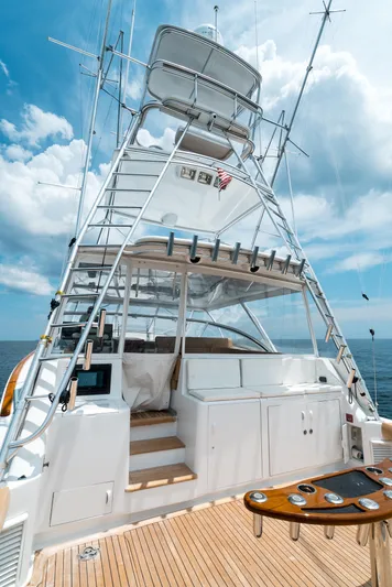 Reel Tycoon Yacht Photos Pics 2004 Donzi R-58 Express yacht with tower, ocean backdrop, and clear sky.