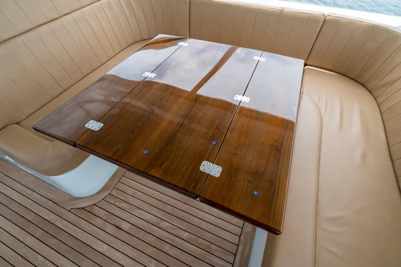 Reel Tycoon Yacht Photos Pics Luxurious seating area on 2004 Donzi R-58 Express yacht with wooden table.