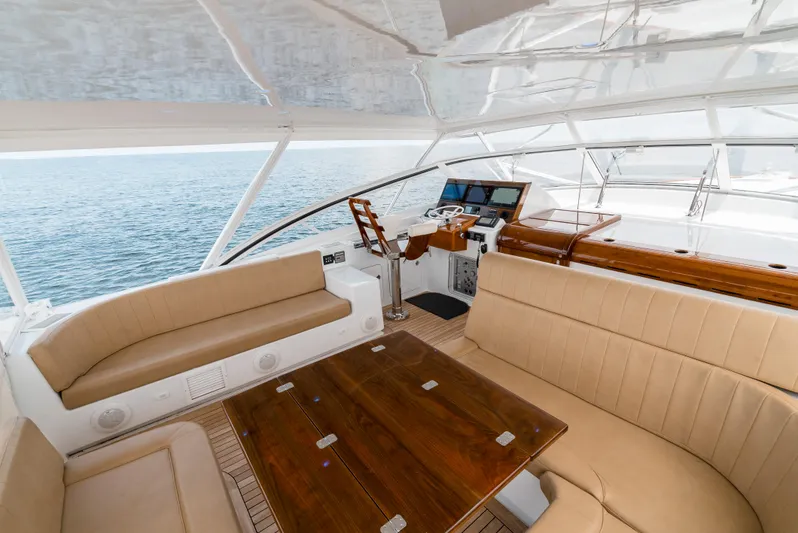Reel Tycoon Yacht Photos Pics Luxurious 2004 Donzi R-58 Express yacht interior with plush seating and wooden table.
