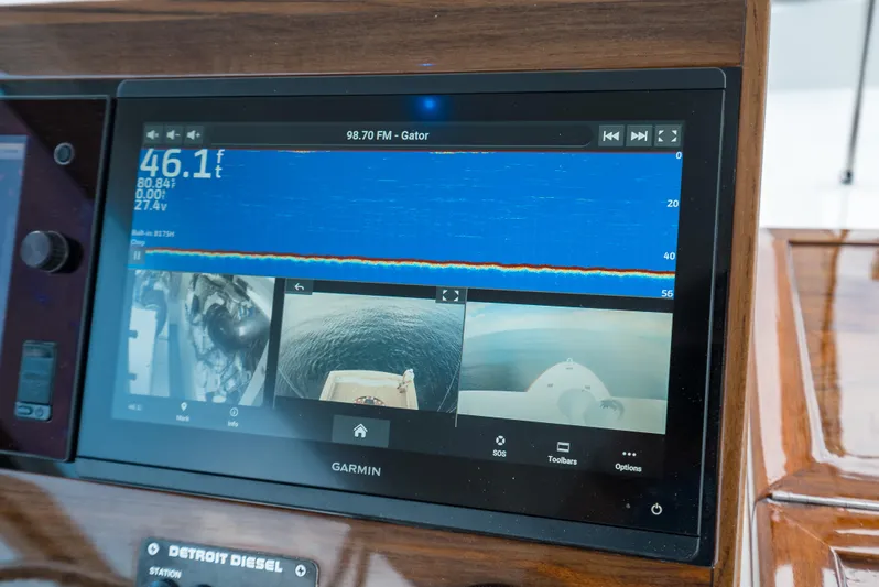 Reel Tycoon Yacht Photos Pics Garmin marine display on 2004 Donzi R-58 Express dashboard, showing sonar and camera feeds.