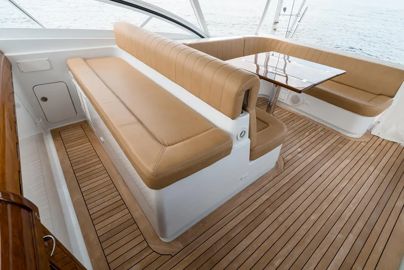 Reel Tycoon Yacht Photos Pics Luxurious seating area on 2004 Donzi R-58 Express yacht with wooden flooring.