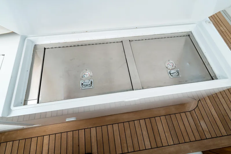 Reel Tycoon Yacht Photos Pics Storage compartment on 2004 Donzi R-58 Express boat with stainless steel lids.