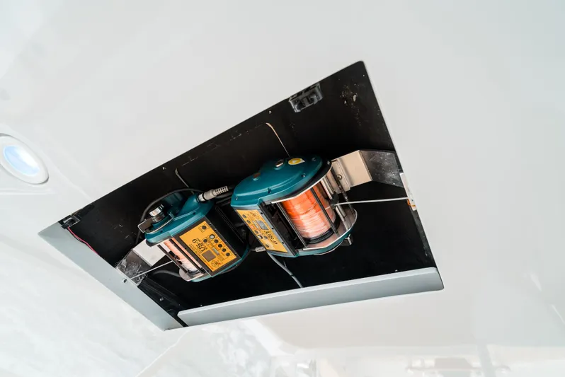 Reel Tycoon Yacht Photos Pics 2004 Donzi R-58 Express fishing reel setup in ceiling compartment.