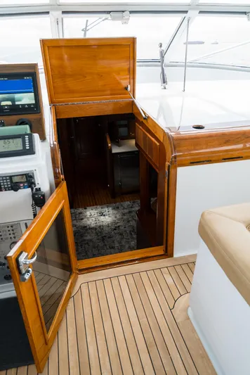 Reel Tycoon Yacht Photos Pics Interior view of 2004 Donzi R-58 Express yacht with wooden finishes and open cabin door.