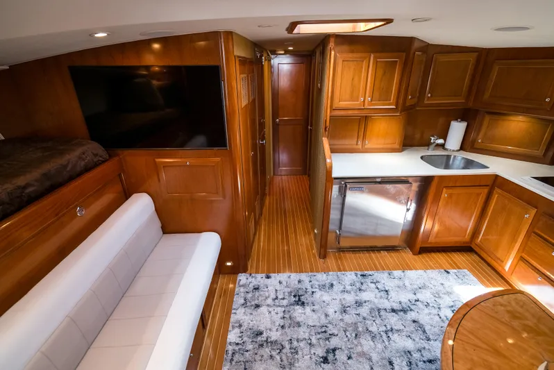 Reel Tycoon Yacht Photos Pics Luxurious 2004 Donzi R-58 Express yacht interior with wood cabinetry and modern amenities.