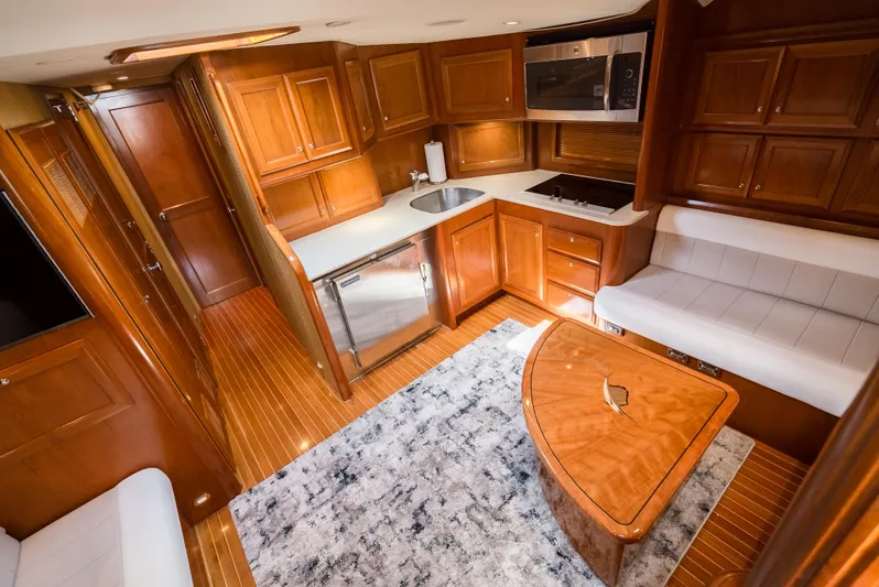 Reel Tycoon Yacht Photos Pics Luxurious 2004 Donzi R-58 Express yacht interior with wood cabinetry and modern amenities.