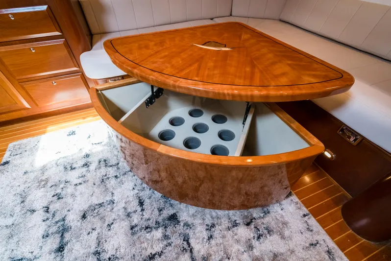 Reel Tycoon Yacht Photos Pics Luxurious 2004 Donzi R-58 Express yacht interior with elegant wooden table and storage.