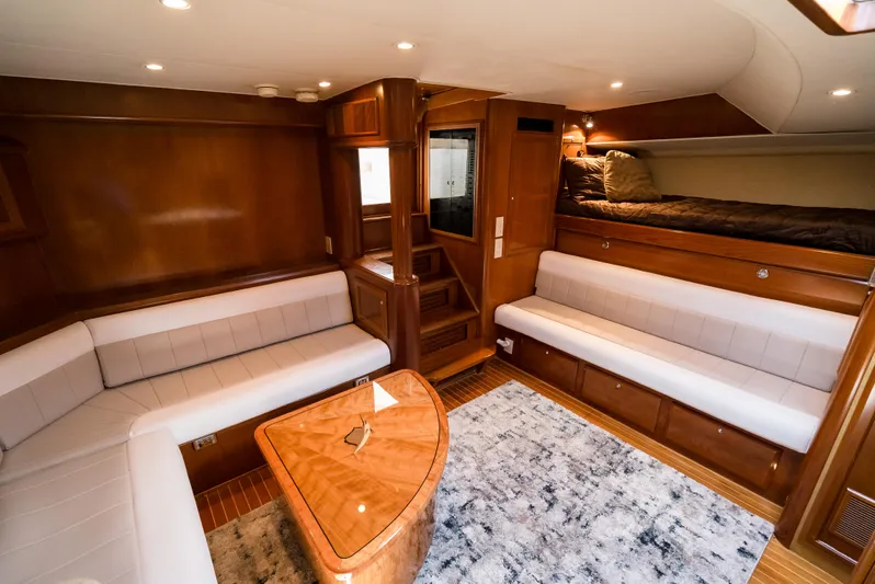Reel Tycoon Yacht Photos Pics Luxurious interior of 2004 Donzi R-58 Express yacht with elegant wood finishes and cozy seating.