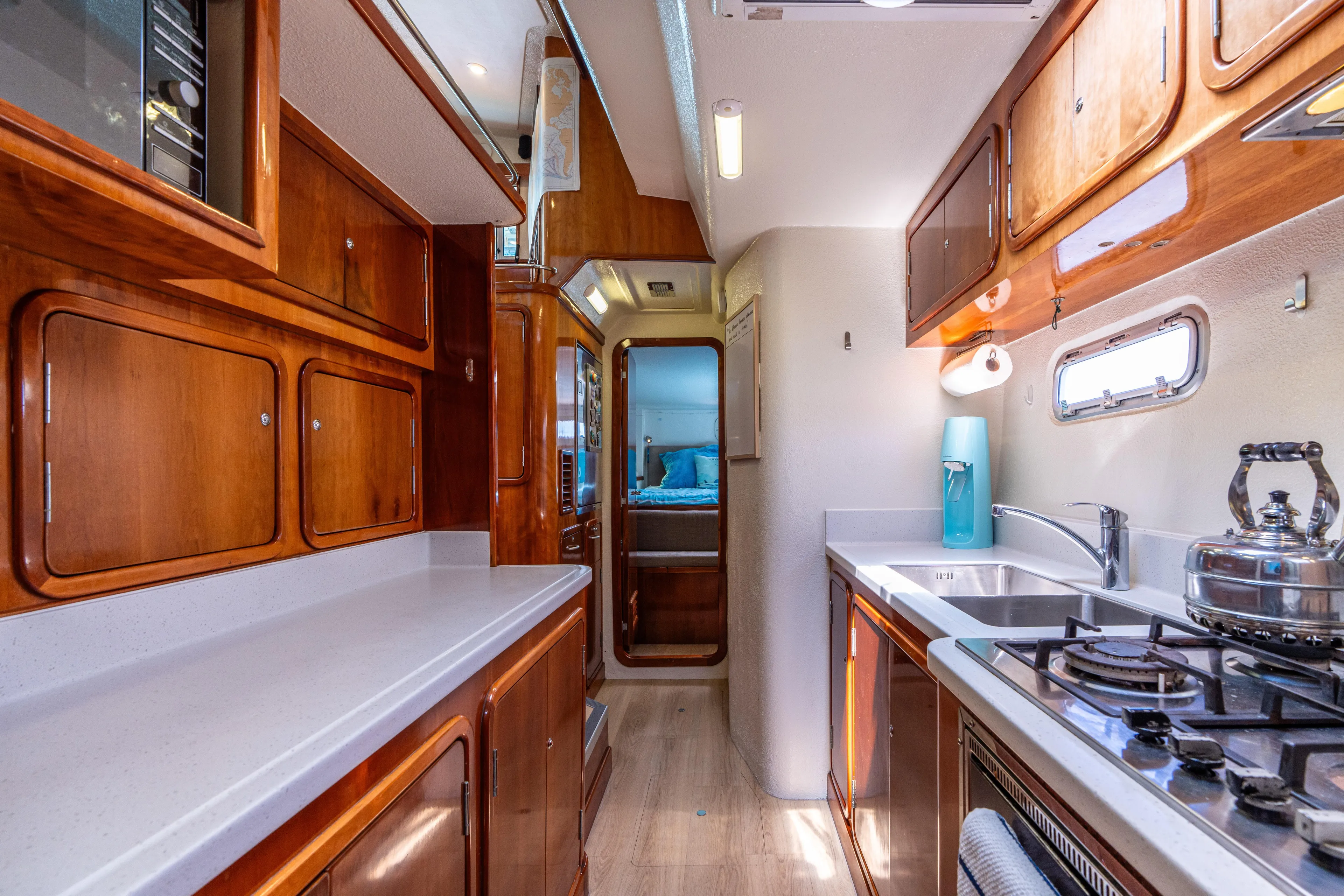 Atlas Yacht Photos Pics Luxurious 2006 St Francis SF50 yacht kitchen with wooden cabinets and modern appliances.