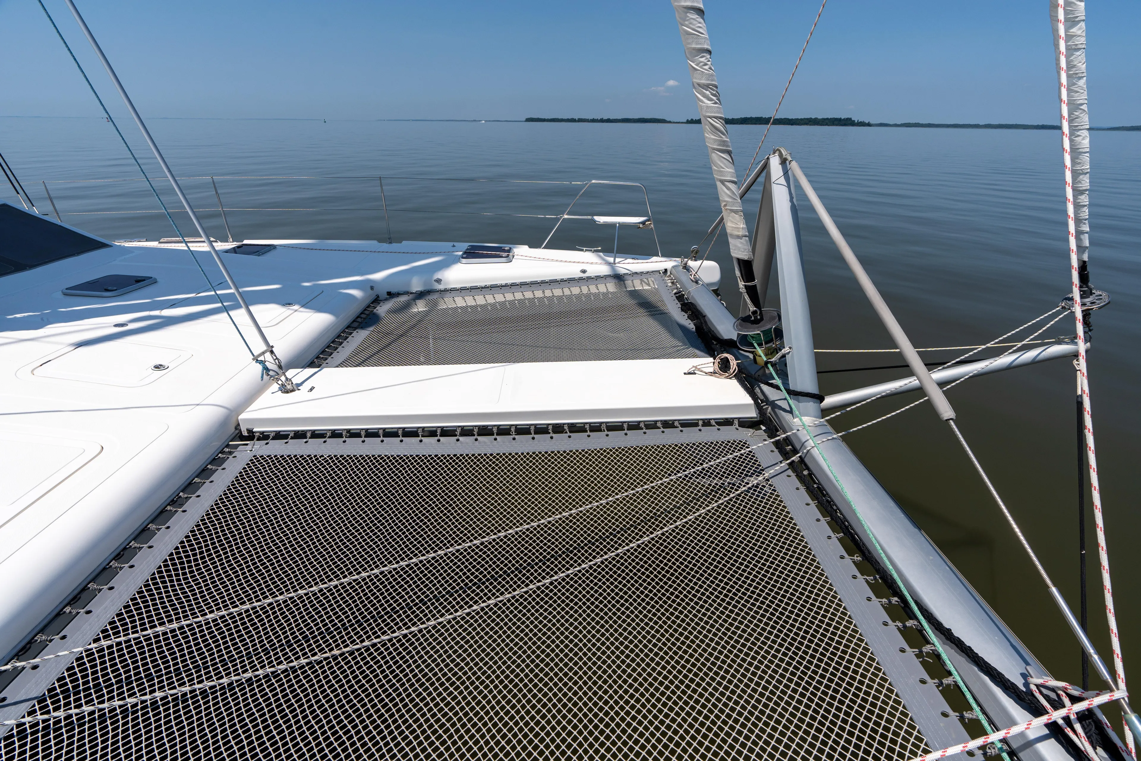 Atlas Yacht Photos Pics Catamaran deck of 2006 St Francis SF50 on calm water, featuring netting and rigging.