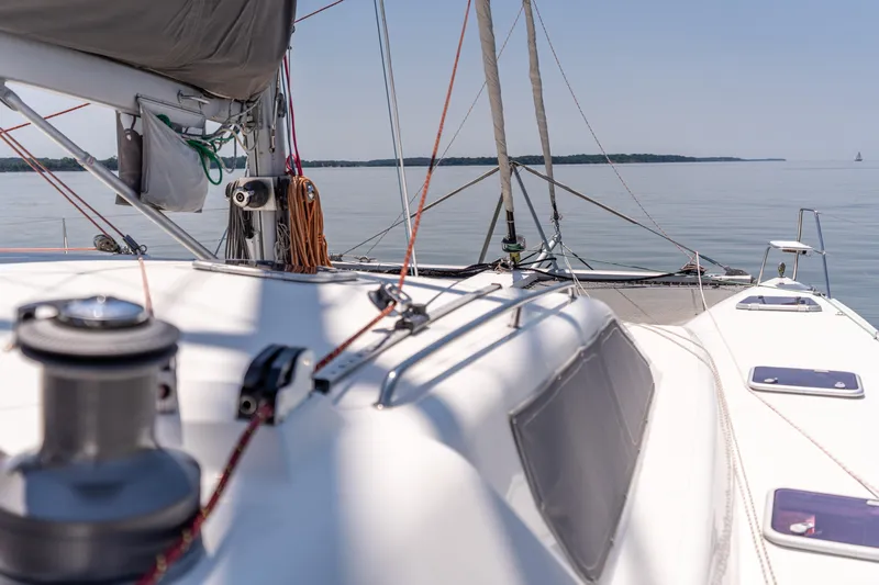 Atlas Yacht Photos Pics Sailing on a 2006 St Francis SF50 catamaran, calm waters, clear sky, distant shoreline.