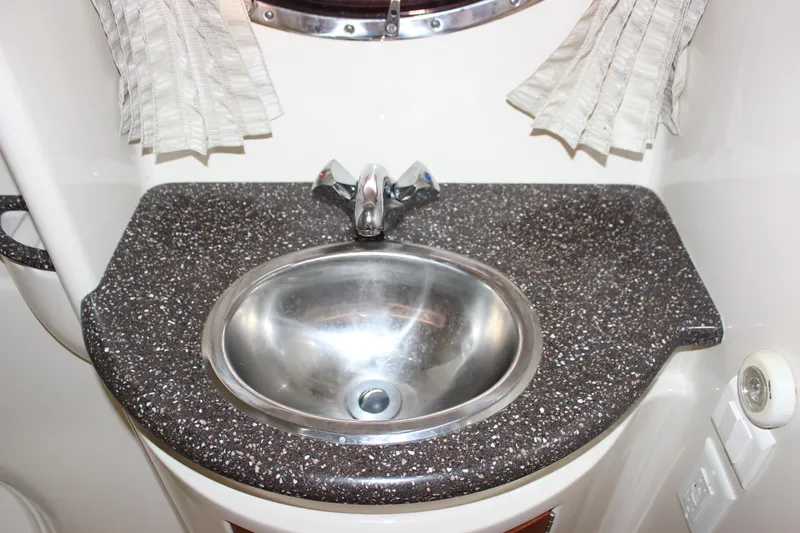  Yacht Photos Pics 2008 Formula 34 Performance Cruiser bathroom sink with speckled countertop and chrome faucet.