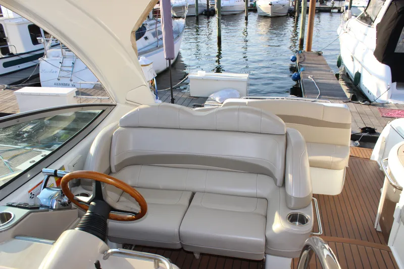  Yacht Photos Pics 2008 Formula 34 Performance Cruiser interior with leather seating and wooden steering wheel at marina.