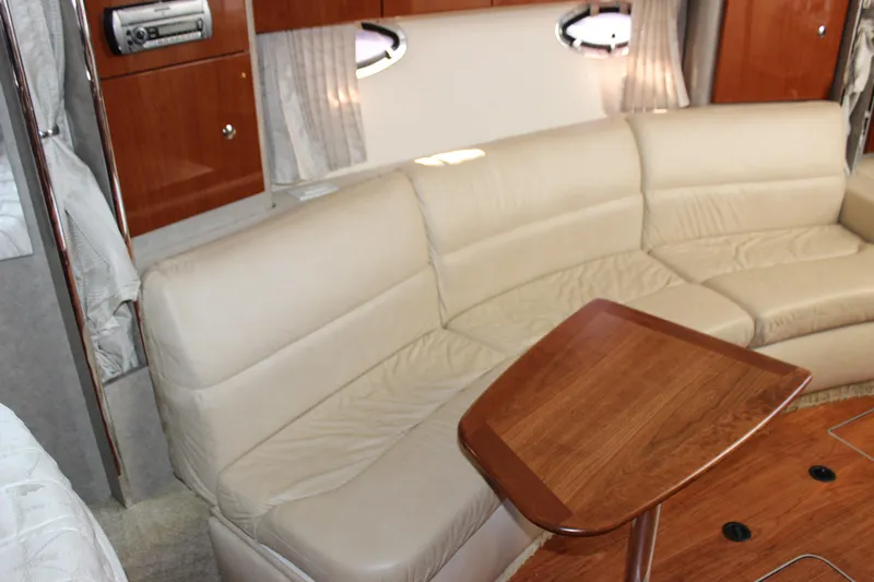  Yacht Photos Pics Interior of 2008 Formula 34 Performance Cruiser with beige leather seating and wooden table.