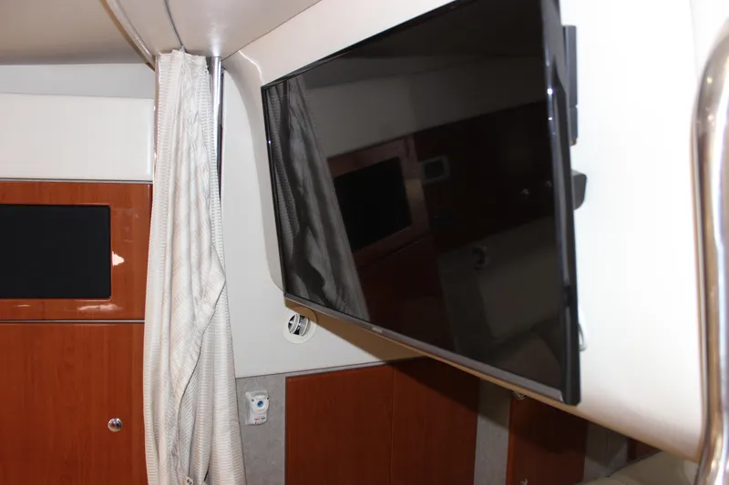  Yacht Photos Pics 2008 Formula 34 Performance Cruiser interior with mounted flat-screen TV and wood paneling.