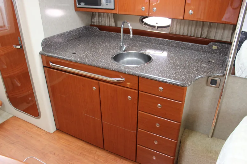  Yacht Photos Pics 2008 Formula 34 Performance Cruiser kitchen with wood cabinets and granite countertop.
