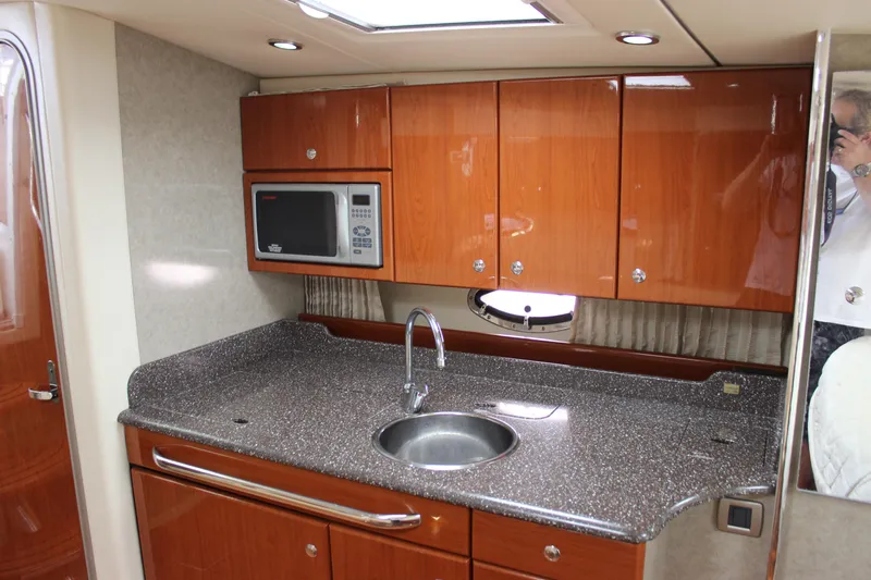  Yacht Photos Pics 2008 Formula 34 Performance Cruiser kitchen with wood cabinets and granite countertop.