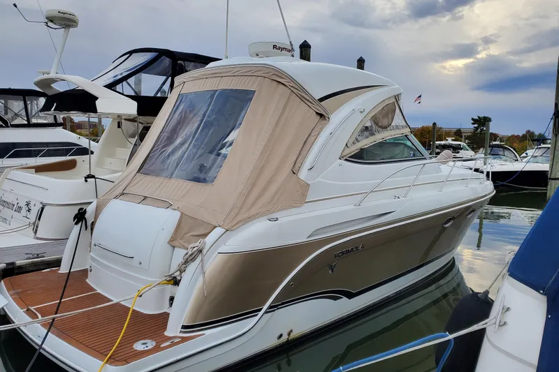  Yacht Photos Pics 2008 Formula 34 Performance Cruiser docked at marina, featuring sleek design and beige canopy.