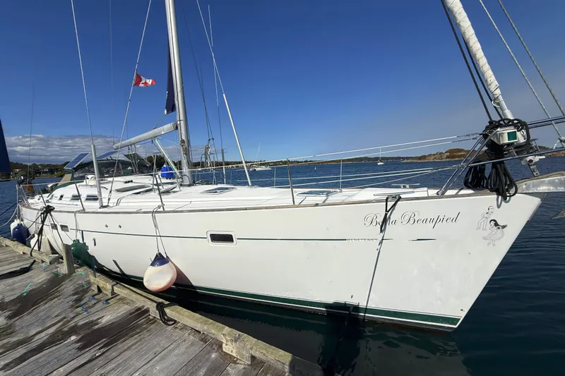 Bellabeaupied Yacht Photos Pics 2004 Beneteau 473 sailboat docked, featuring sleek white design and Canadian flag.