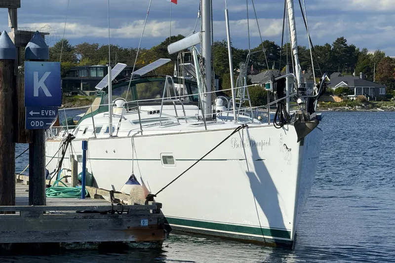 Bellabeaupied Yacht Photos Pics 2004 Beneteau 473 sailboat docked at a marina with scenic background.