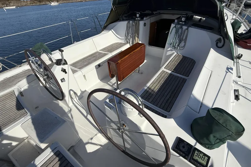 Bellabeaupied Yacht Photos Pics Cockpit of 2004 Beneteau 473 sailboat with dual steering wheels and teak seating.