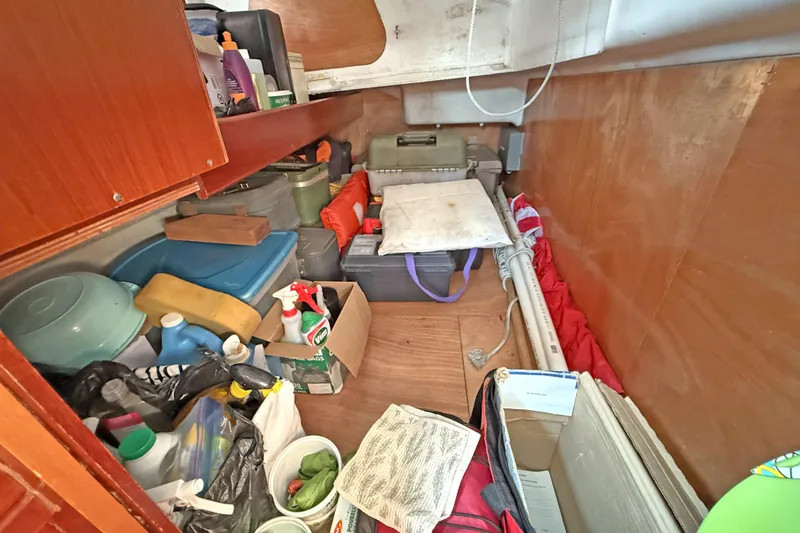 Bellabeaupied Yacht Photos Pics Storage area on a 2004 Beneteau 473 sailboat, filled with various supplies and equipment.