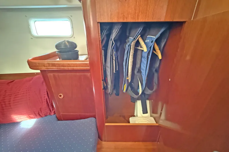 Bellabeaupied Yacht Photos Pics Interior of 2004 Beneteau 473 yacht with life jackets in wooden cabinet.