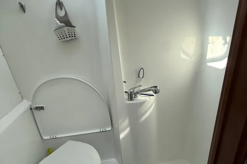 Bellabeaupied Yacht Photos Pics Bathroom interior of 2004 Beneteau 473 yacht, featuring a compact shower and toilet.
