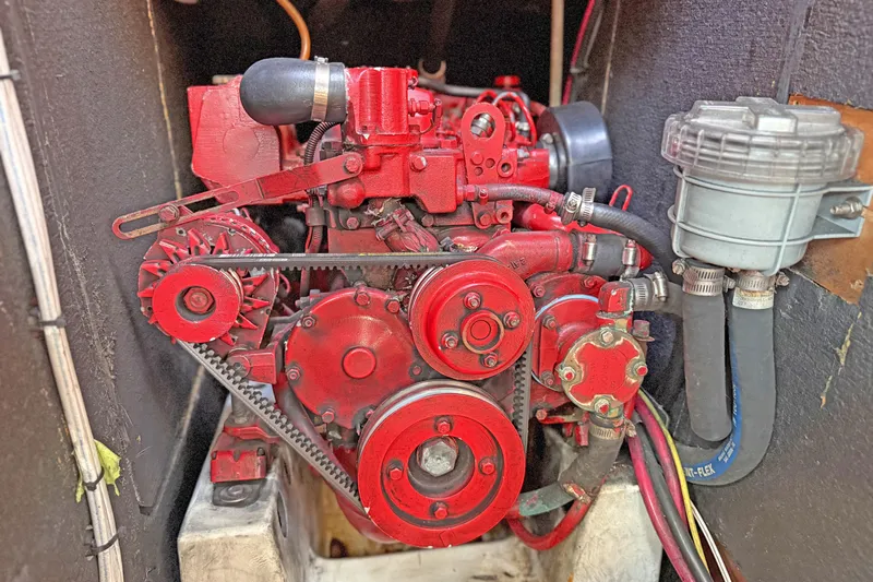 Bellabeaupied Yacht Photos Pics Red engine of a 2004 Beneteau 473 sailboat, showcasing mechanical components.